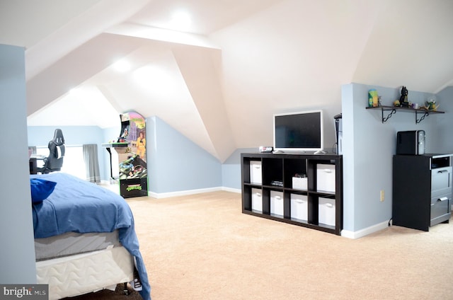 carpeted bedroom with lofted ceiling