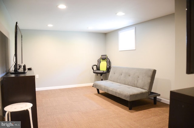 sitting room featuring light colored carpet