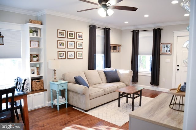 living room featuring crown molding, hardwood / wood-style floors, and ceiling fan