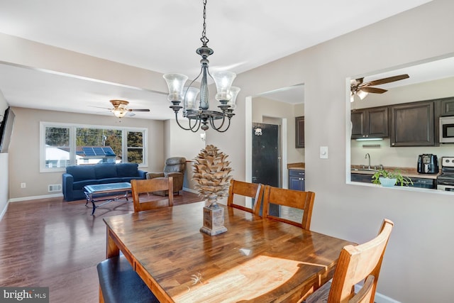 dining room with dark hardwood / wood-style flooring, sink, and ceiling fan