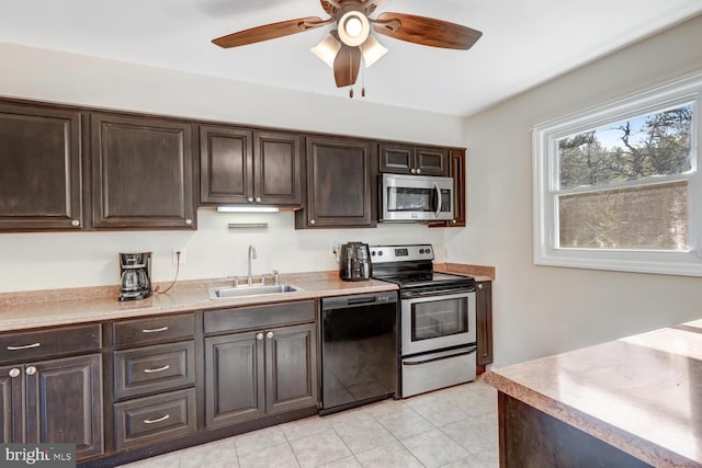 kitchen featuring appliances with stainless steel finishes, sink, light tile patterned floors, ceiling fan, and dark brown cabinets