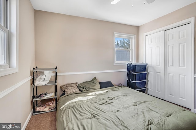 bedroom featuring ceiling fan, a closet, and carpet