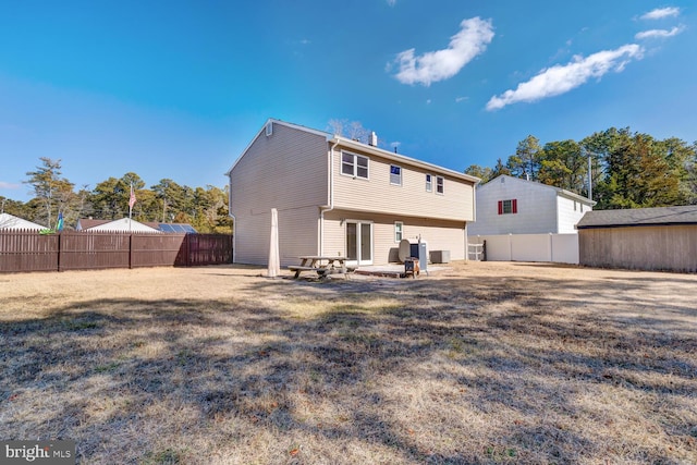 back of property featuring a yard and a patio area