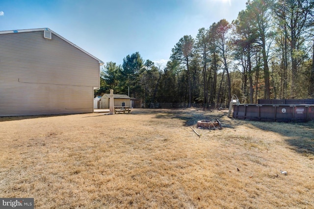 view of yard with a fire pit