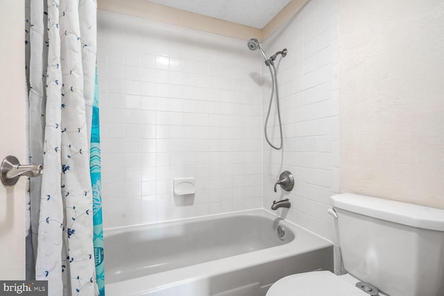 bathroom with shower / bath combination with curtain and toilet