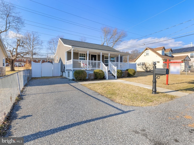 view of front facade with a front yard and covered porch