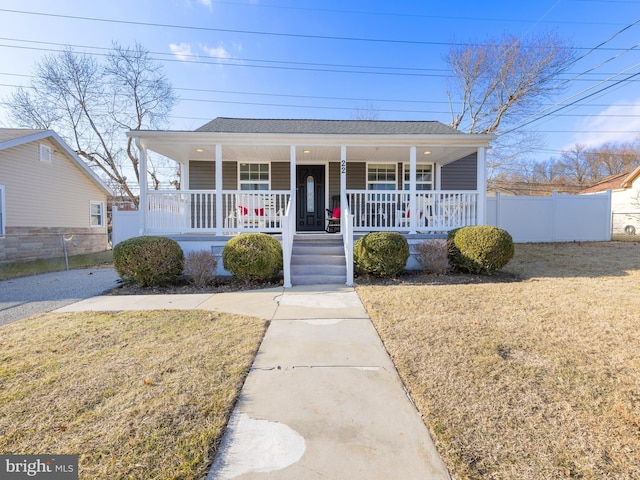 bungalow-style house with covered porch and a front lawn