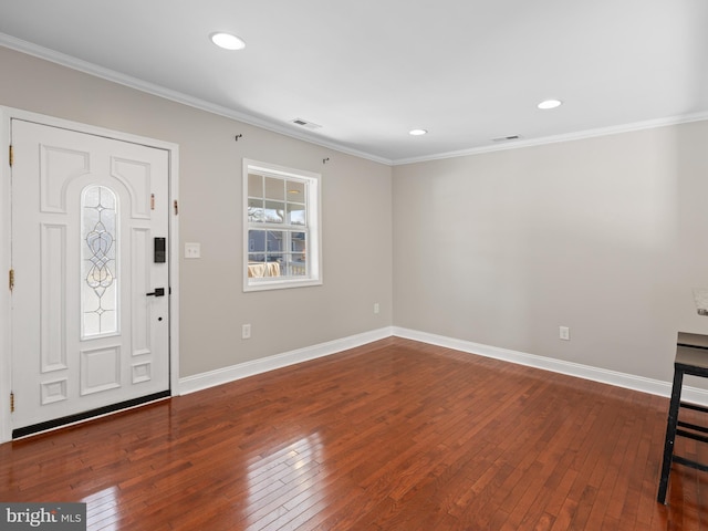 entryway with ornamental molding and hardwood / wood-style floors