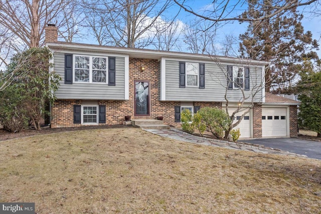 bi-level home featuring a garage and a front yard