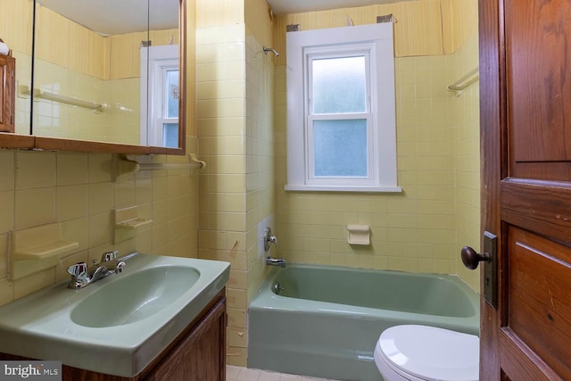 264 S Main St, Pleasant Gap, PA 16823 - bathroom with vanity, washtub / shower combination, tile walls, backsplash, and toilet
