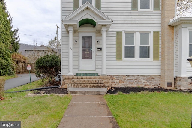 264 S Main St, Pleasant Gap, PA 16823 - view of exterior entry with a chimney and a yard