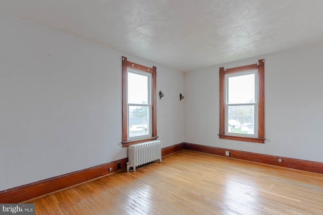 264 S Main St, Pleasant Gap, PA 16823 - empty room with radiator heating unit, a wealth of natural light, baseboards, and light wood-type flooring