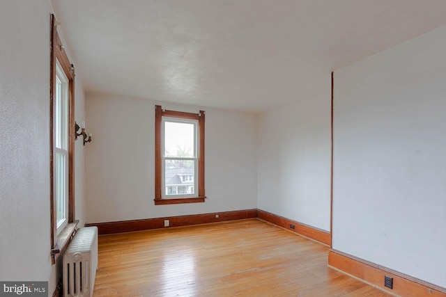 264 S Main St, Pleasant Gap, PA 16823 - empty room with radiator heating unit, baseboards, and light wood-style flooring