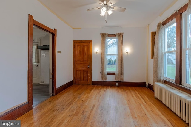 264 S Main St, Pleasant Gap, PA 16823 - empty room with a ceiling fan, baseboards, radiator heating unit, and light wood-style floors