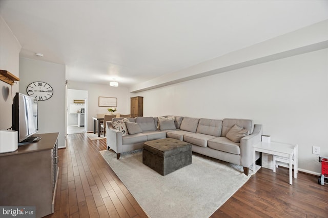 living room with dark hardwood / wood-style flooring