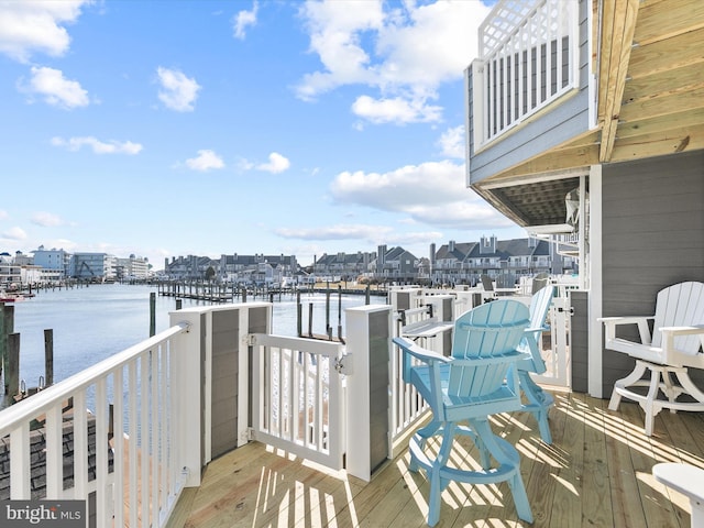 balcony featuring a water view and a dock