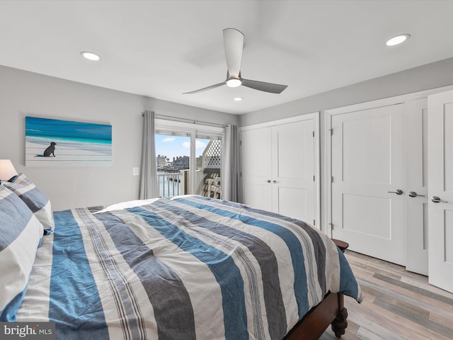 bedroom with multiple closets, ceiling fan, light hardwood / wood-style floors, and access to outside