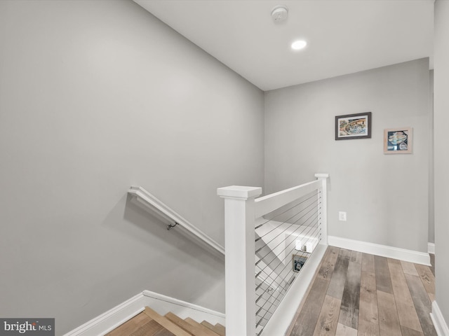 stairway featuring hardwood / wood-style floors