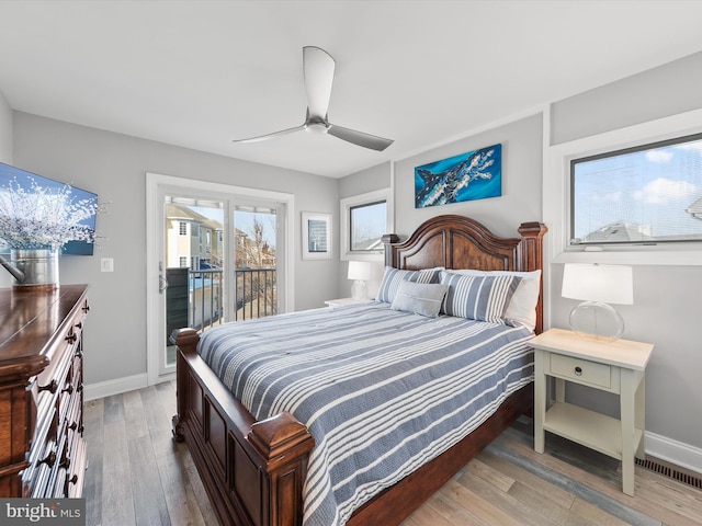 bedroom featuring ceiling fan, wood-type flooring, and access to outside