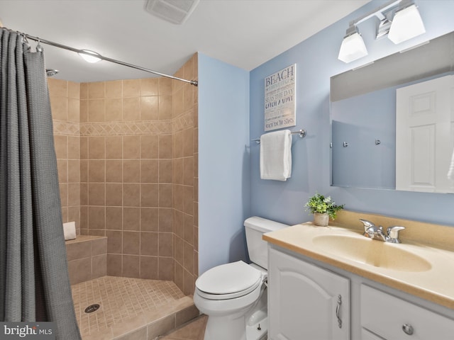 bathroom with vanity, toilet, and walk in shower