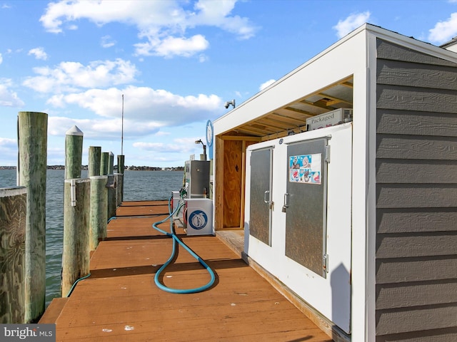 wooden terrace featuring a water view and a boat dock