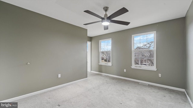 empty room featuring light carpet and ceiling fan