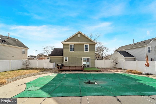 rear view of house with a swimming pool side deck