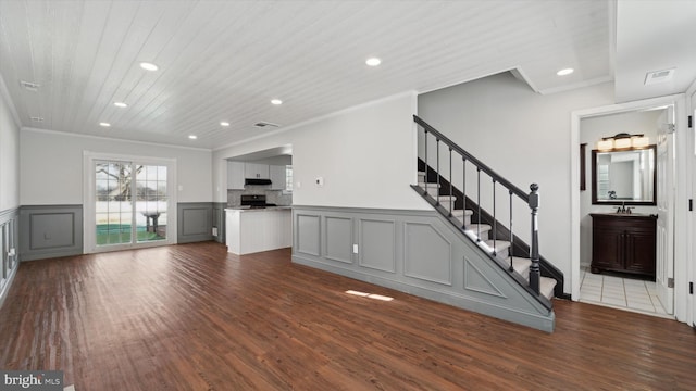 unfurnished living room featuring crown molding, dark wood-type flooring, and wooden ceiling