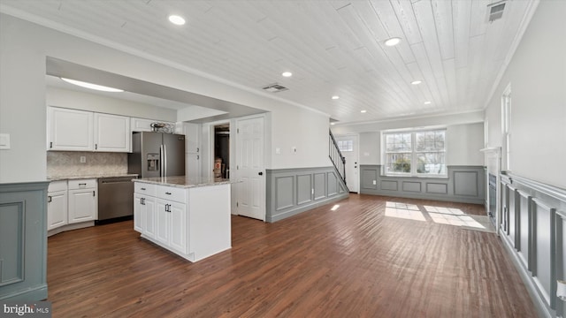 kitchen with wood ceiling, light stone counters, a center island, stainless steel appliances, and white cabinets