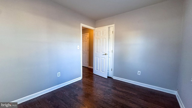 spare room with dark hardwood / wood-style floors