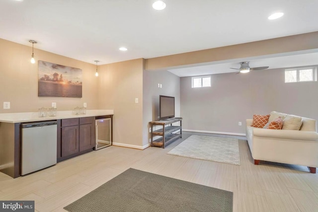 kitchen featuring decorative light fixtures, light countertops, open floor plan, beverage cooler, and dishwasher