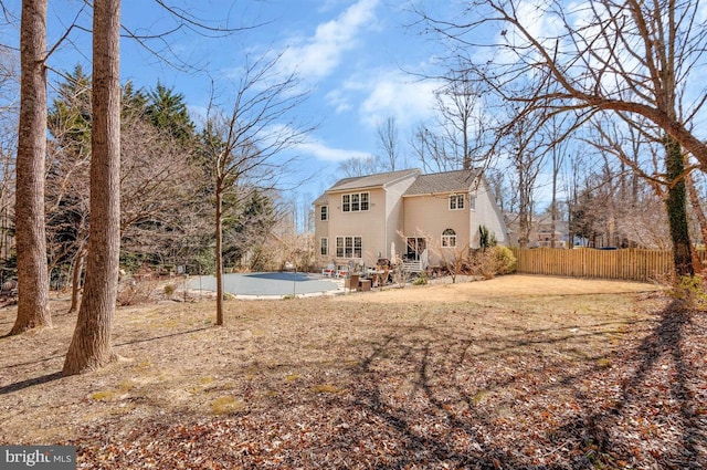 rear view of property with fence