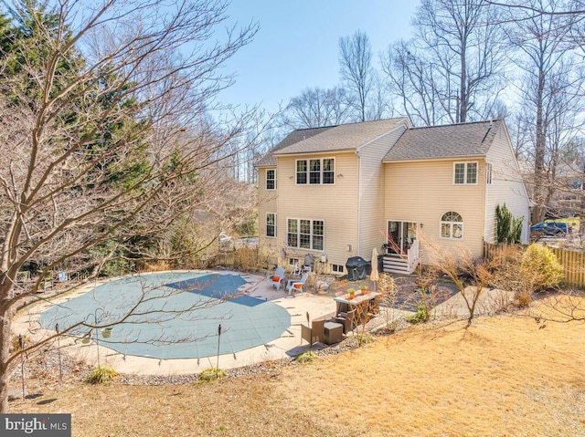 view of swimming pool with entry steps, a patio area, fence, and a fenced in pool