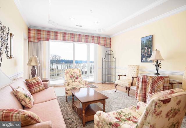 living room with hardwood / wood-style flooring and ornamental molding