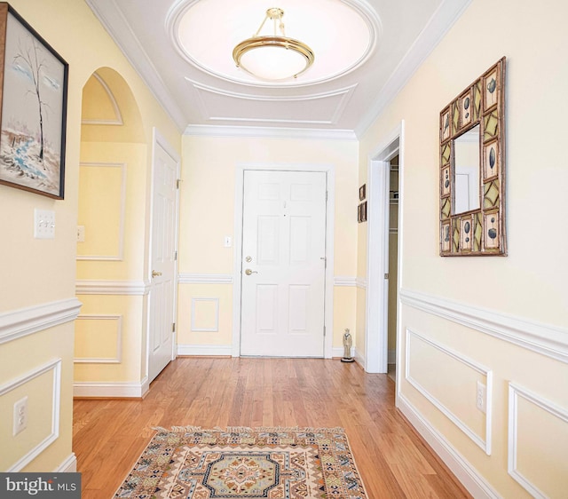 interior space with ornamental molding and light hardwood / wood-style flooring