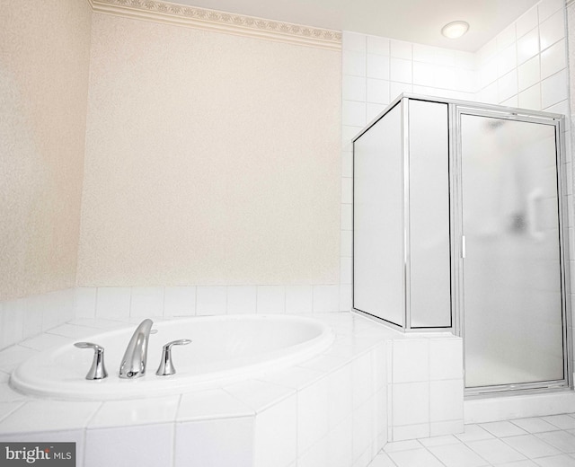 bathroom with tile patterned floors and independent shower and bath