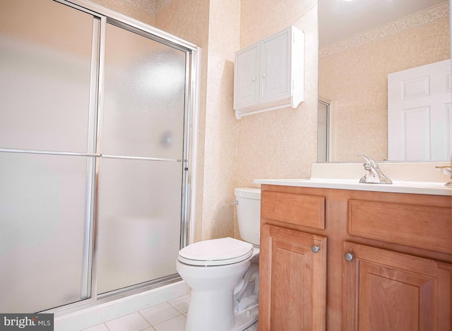 bathroom featuring vanity, toilet, a shower with shower door, and tile patterned flooring