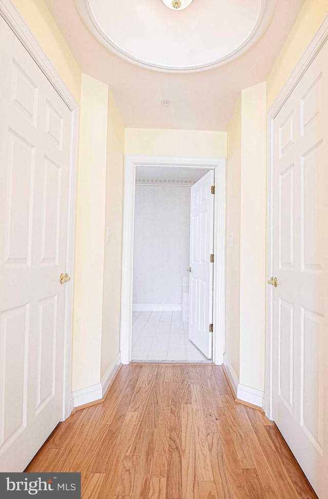 corridor with light hardwood / wood-style floors