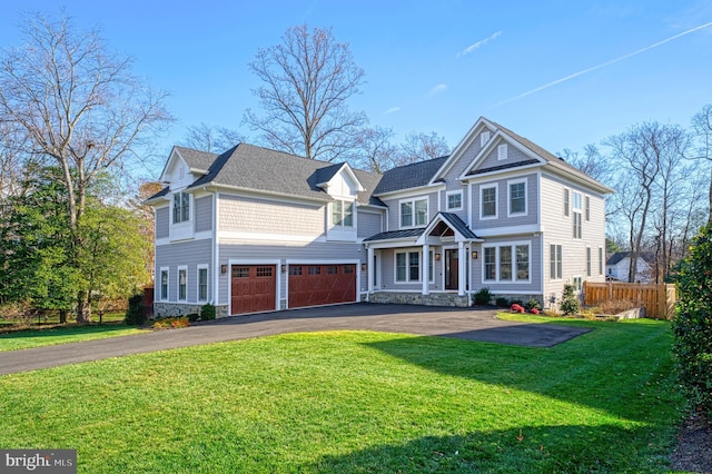 view of front of property featuring a garage and a front yard