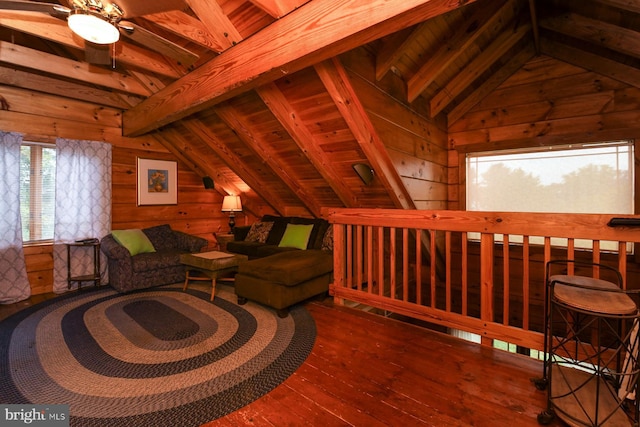 living room featuring hardwood / wood-style floors, lofted ceiling with beams, wooden ceiling, and wood walls