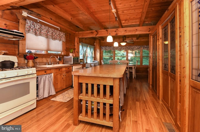 kitchen featuring sink, wood ceiling, hanging light fixtures, light hardwood / wood-style flooring, and white appliances