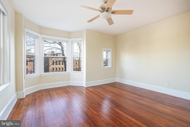 unfurnished room featuring dark hardwood / wood-style flooring and ceiling fan