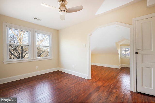 empty room with ceiling fan, lofted ceiling, and dark hardwood / wood-style floors