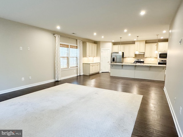 unfurnished living room featuring dark hardwood / wood-style flooring