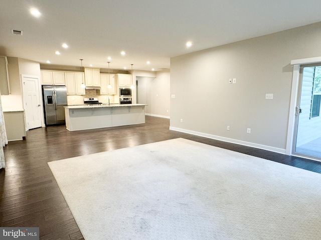 unfurnished living room with dark hardwood / wood-style flooring