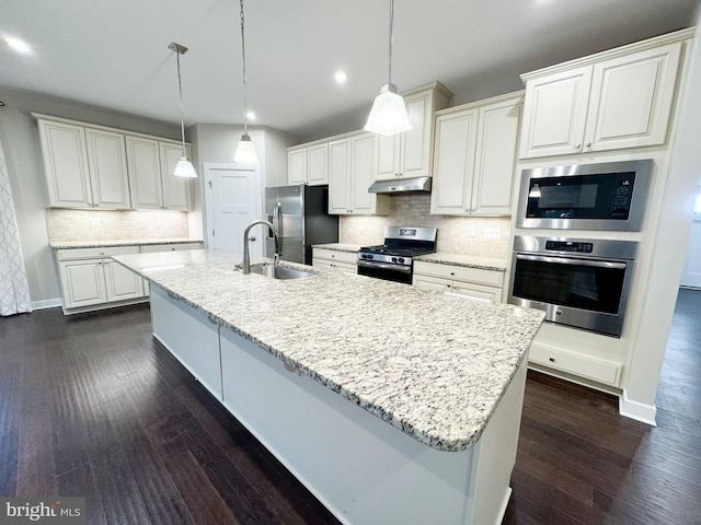 kitchen with sink, decorative light fixtures, white cabinets, and appliances with stainless steel finishes