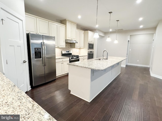 kitchen featuring hanging light fixtures, appliances with stainless steel finishes, and light stone counters