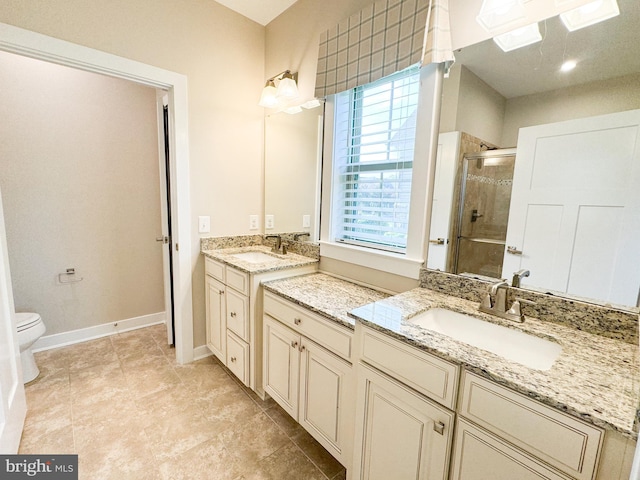 bathroom with an enclosed shower, vanity, and toilet