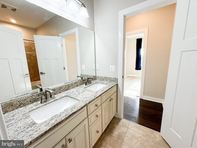 bathroom with vanity, tile patterned flooring, and washtub / shower combination