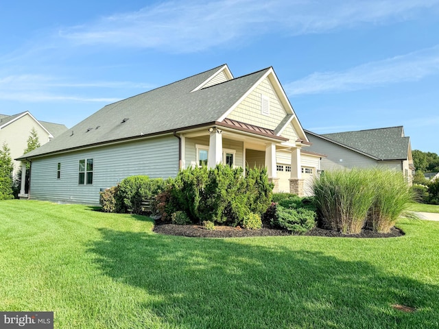 view of side of home with a lawn